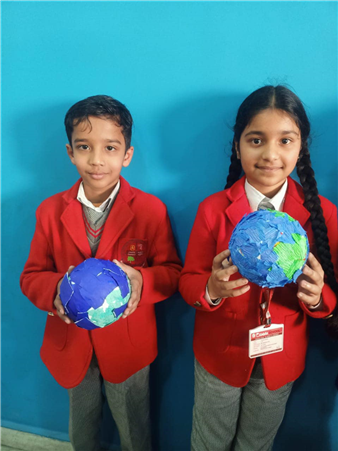 Our Miniature Marvel! Students of Grade II proudly presenting the handmade model of the Earth, showcasing its  beauty.